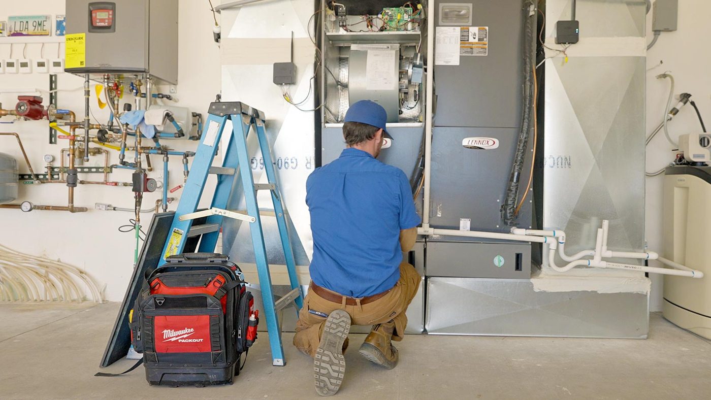 Nichols technician servicing a furnace
