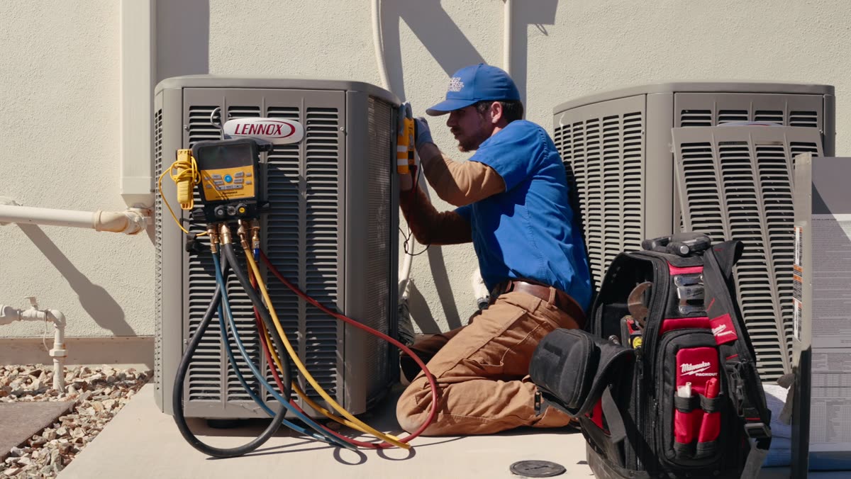 Nichols technician checking an AC condenser with gauges